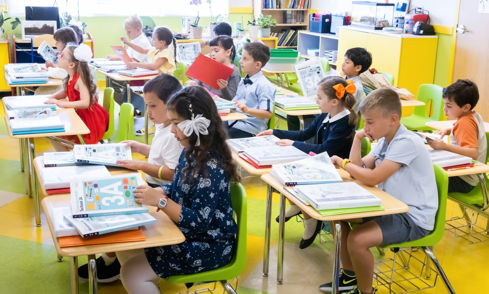 Starbright elementary students working through Singapore Math workbooks at their desks