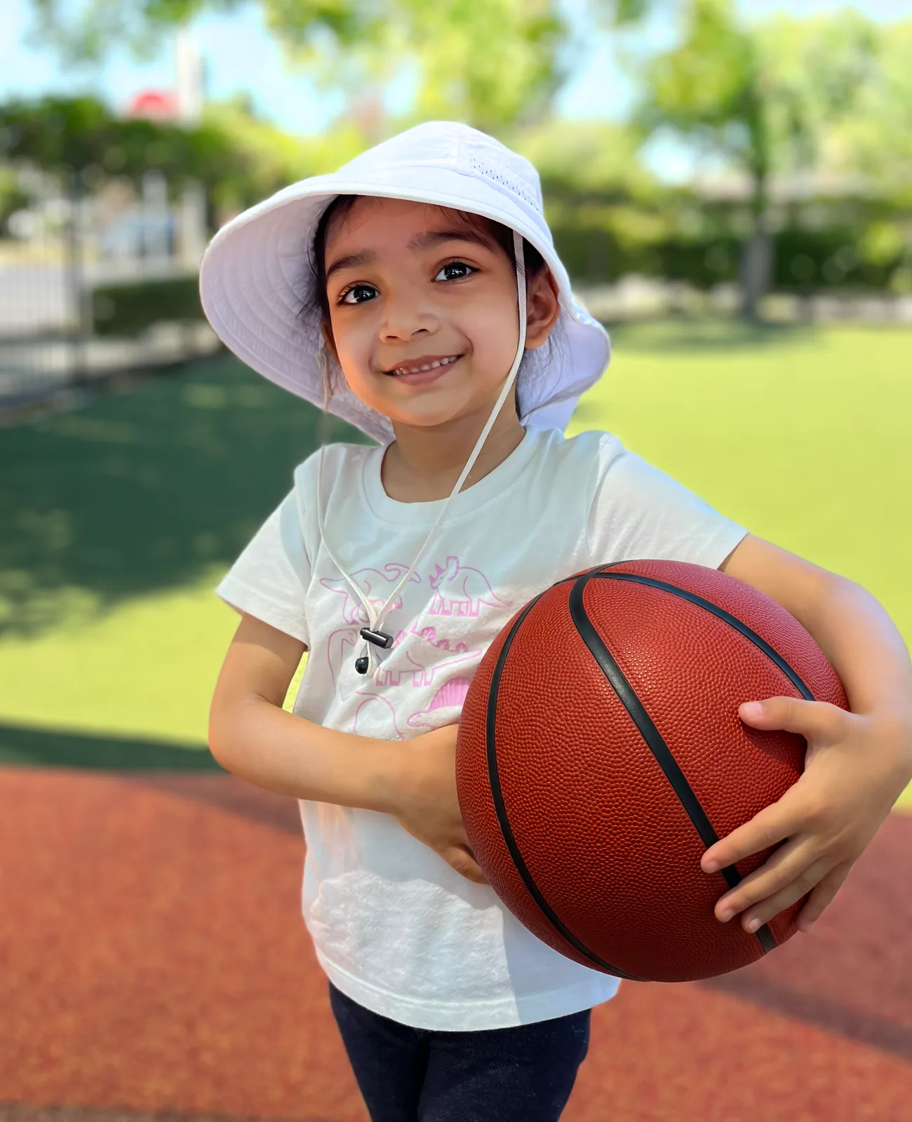 A Starbright student holding a basketball outdoors