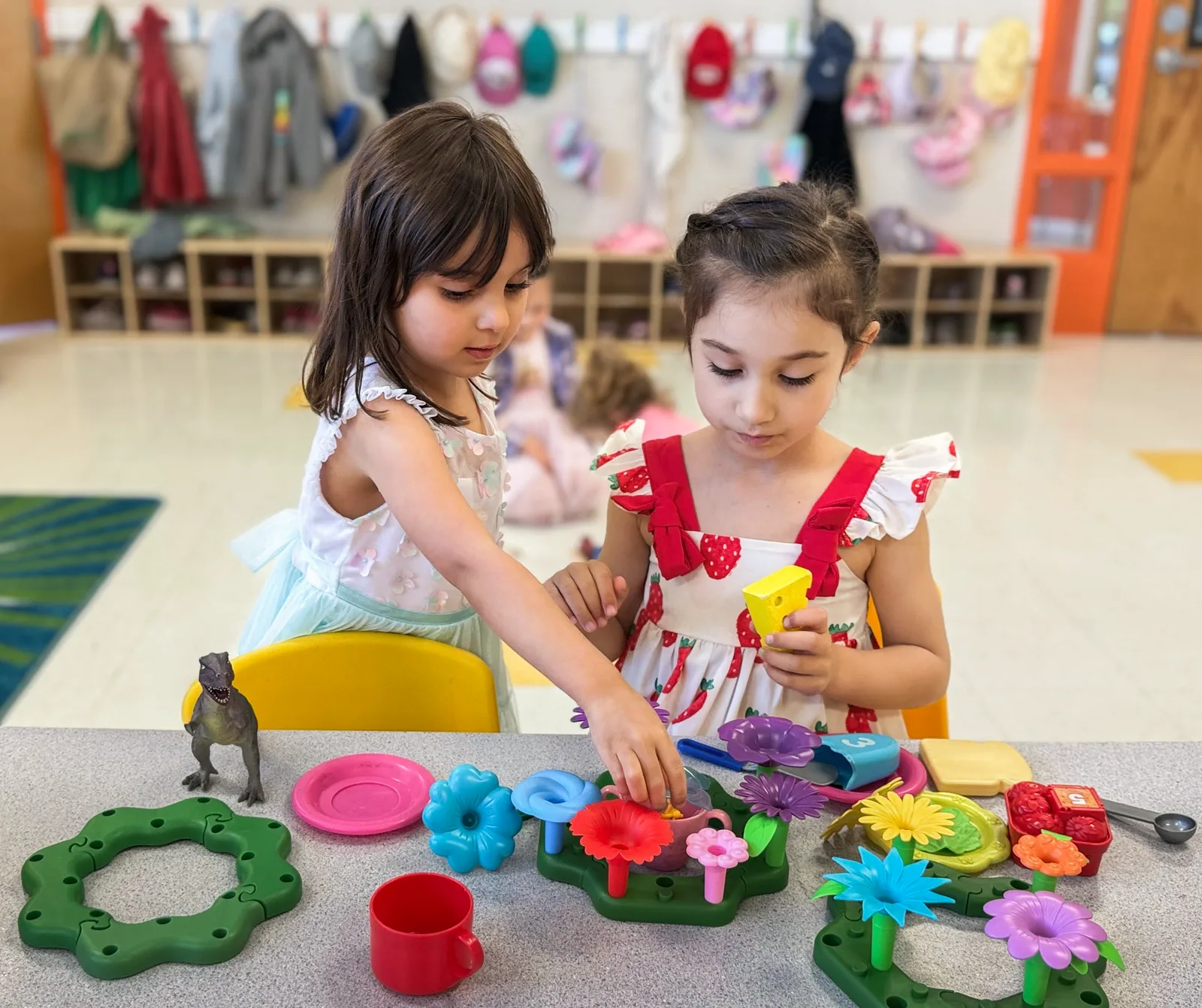 Two Starbright preschoolers playing together with a toy flower garden
