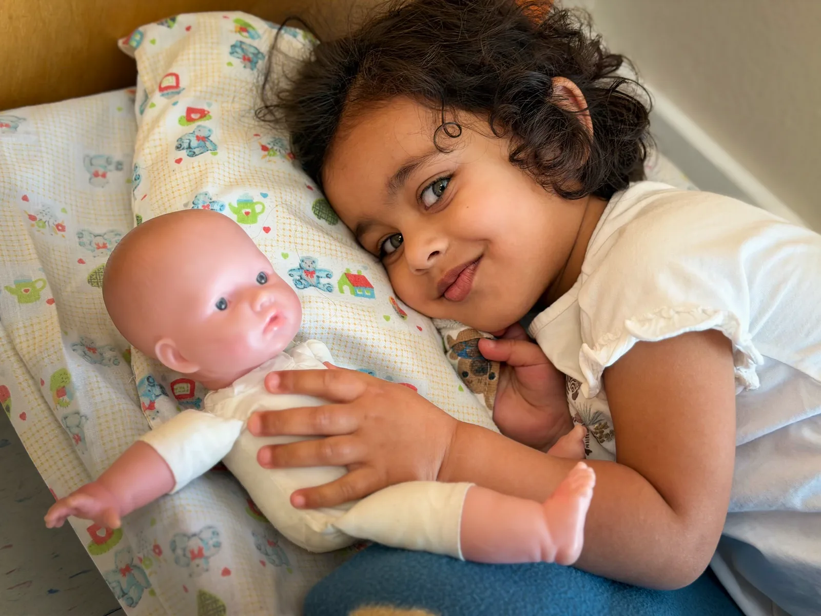 A Starbright child resting quietly with a doll
