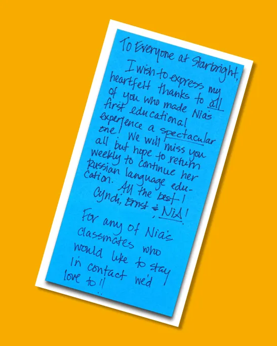 A handwritten thank-you letter on blue paper