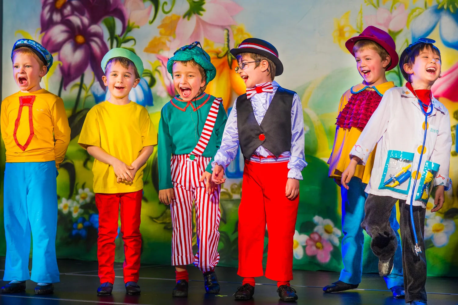 Young Starbright performers singing together in colorful costumes